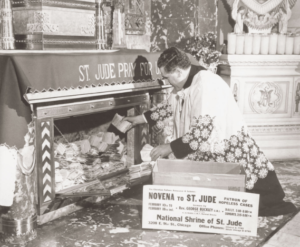 historical-photo-of-priest-kneeling-at-shrine